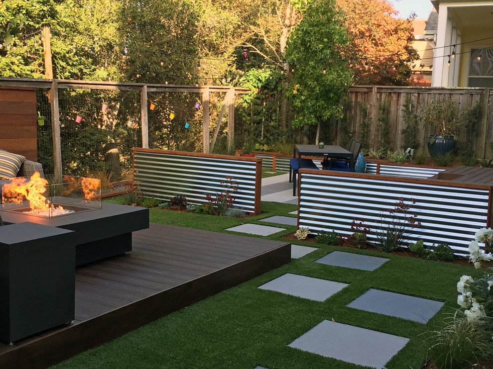Photo of a small contemporary drought-tolerant and partial sun backyard landscaping in San Francisco with a fire pit and decking for fall.