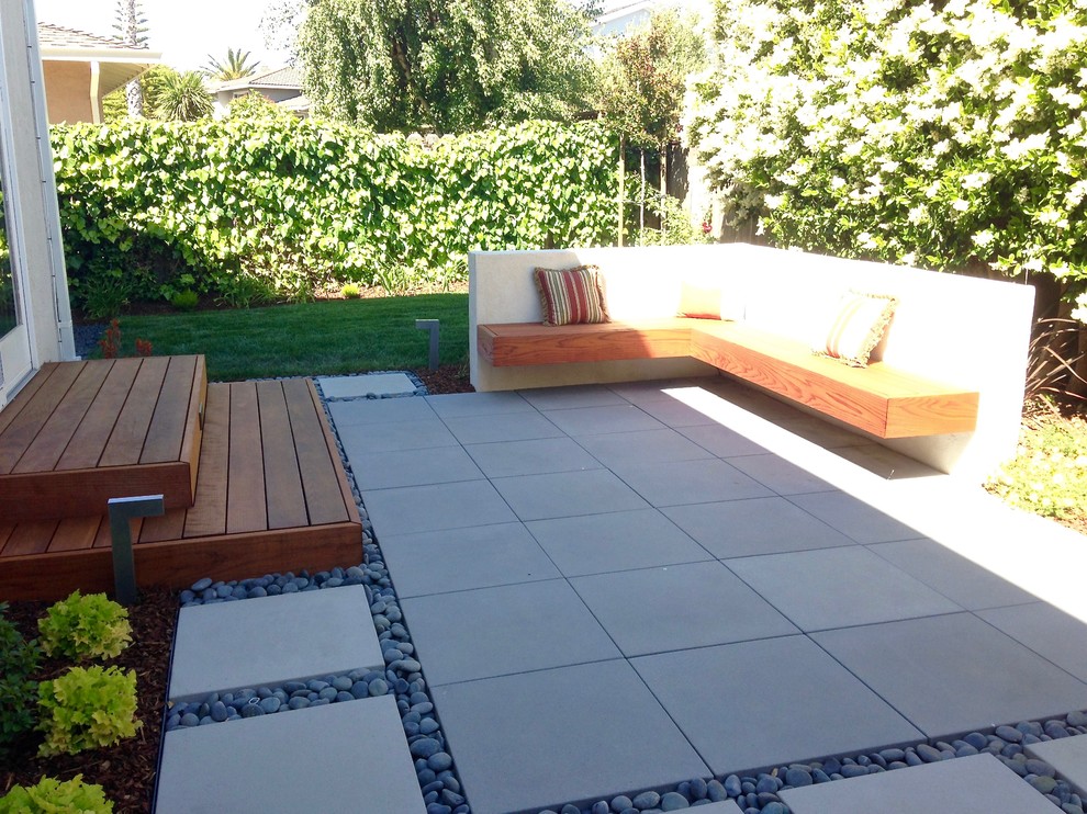This is an example of a medium sized contemporary back partial sun garden for summer in San Francisco with concrete paving.