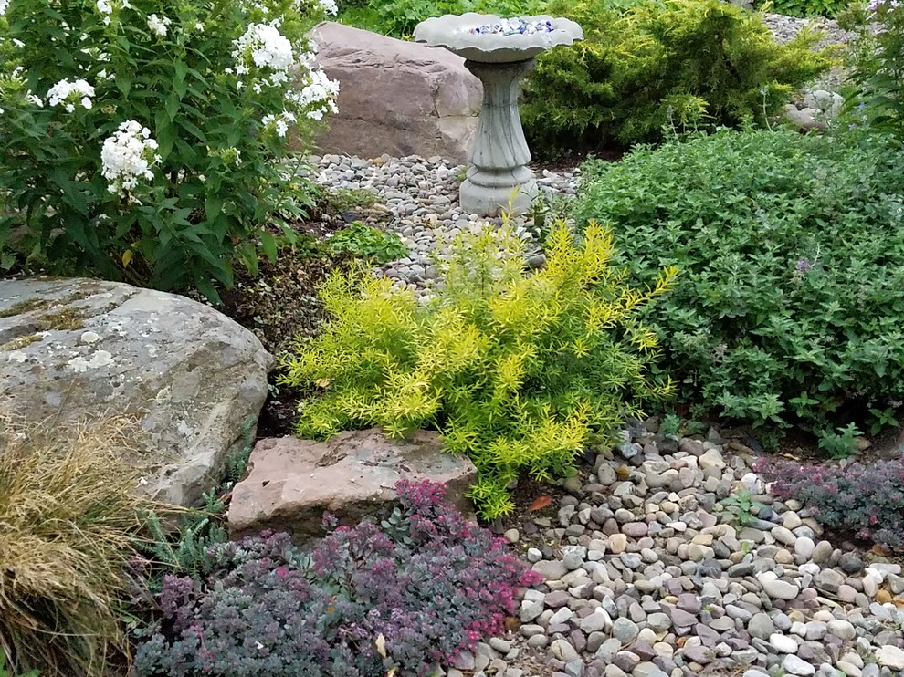 Design ideas for a large world-inspired back xeriscape partial sun garden in New York with a garden path and natural stone paving.