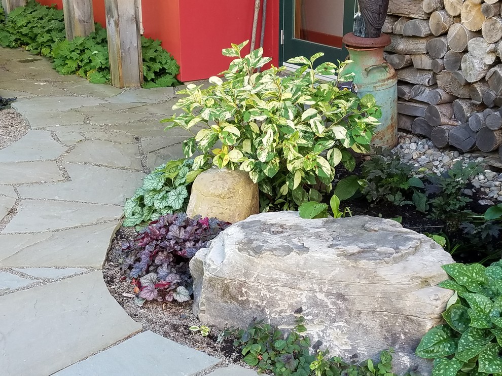 Photo of a large world-inspired back xeriscape partial sun garden in New York with a garden path and natural stone paving.