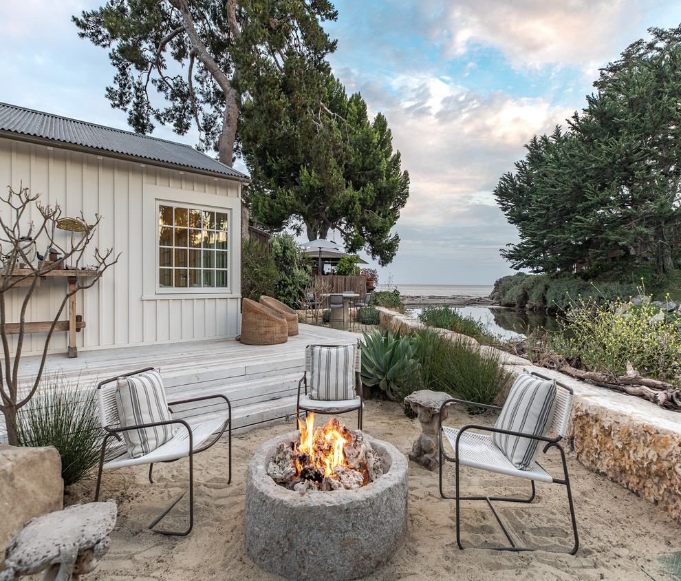 Photo of a medium sized beach style back full sun garden for summer in San Luis Obispo with a fire feature.