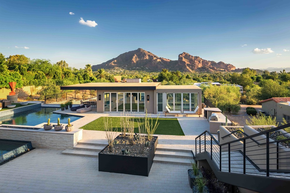 Photo of a large contemporary back full sun garden in Phoenix.