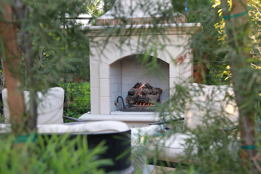 This is an example of a small mediterranean partial sun backyard landscaping in Los Angeles with a fire pit for fall.