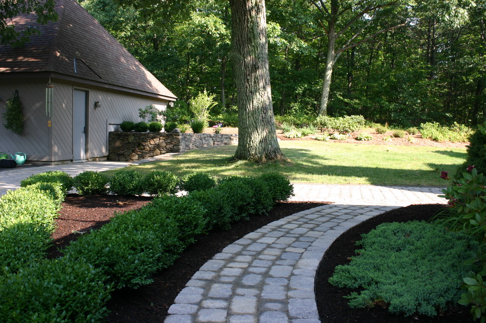 Medium sized contemporary front driveway fully shaded garden for summer in Bridgeport with a garden path and brick paving.