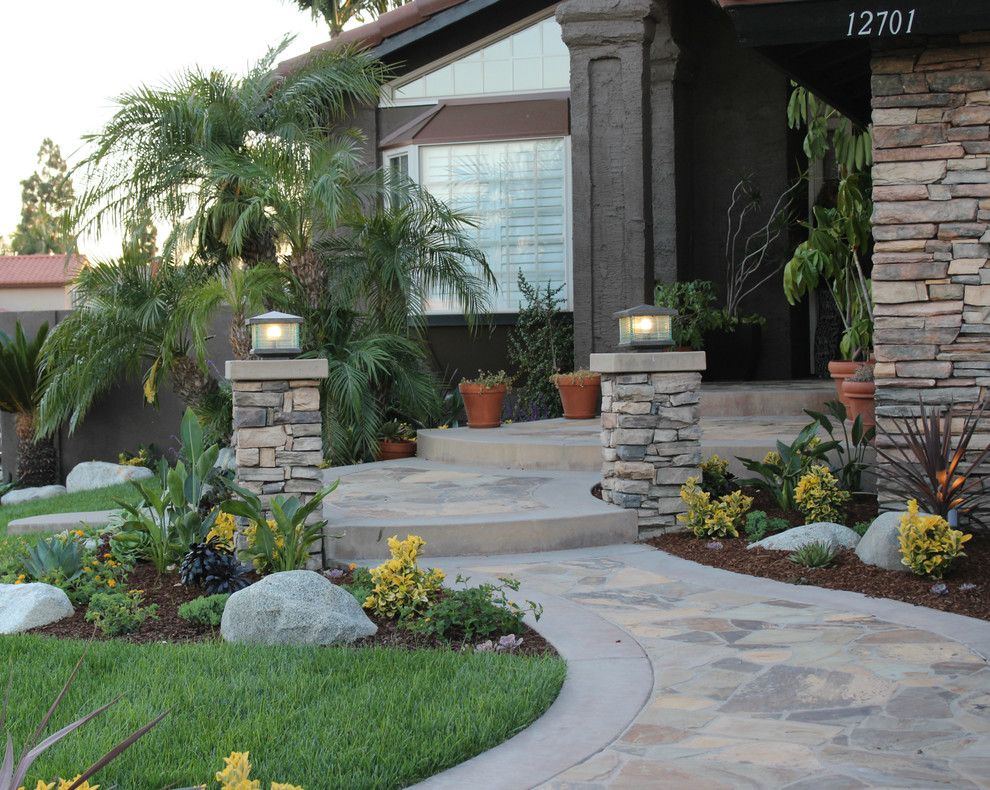 Inspiration for a mid-sized contemporary drought-tolerant and partial sun front yard stone garden path in Orange County for summer.