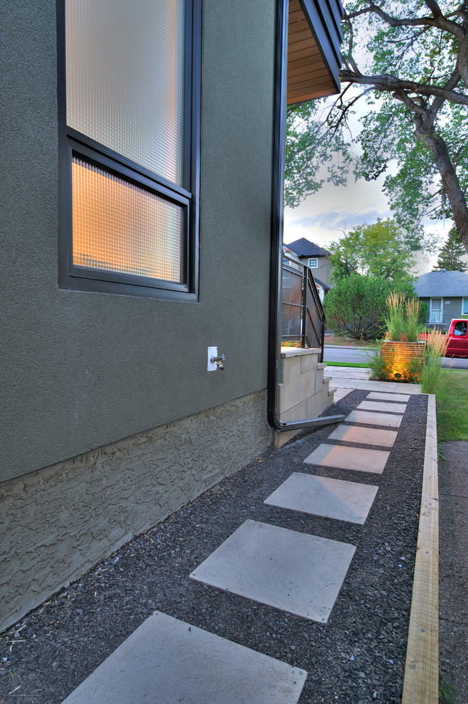 Small contemporary side full sun garden in Calgary with a garden path and concrete paving.