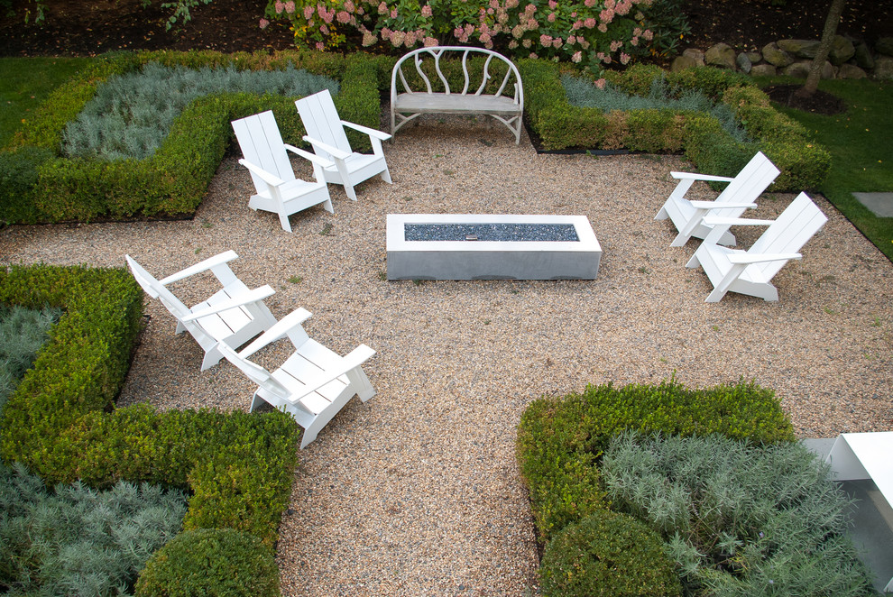 Photo of a large contemporary full sun backyard formal garden in Boston with a fire pit.