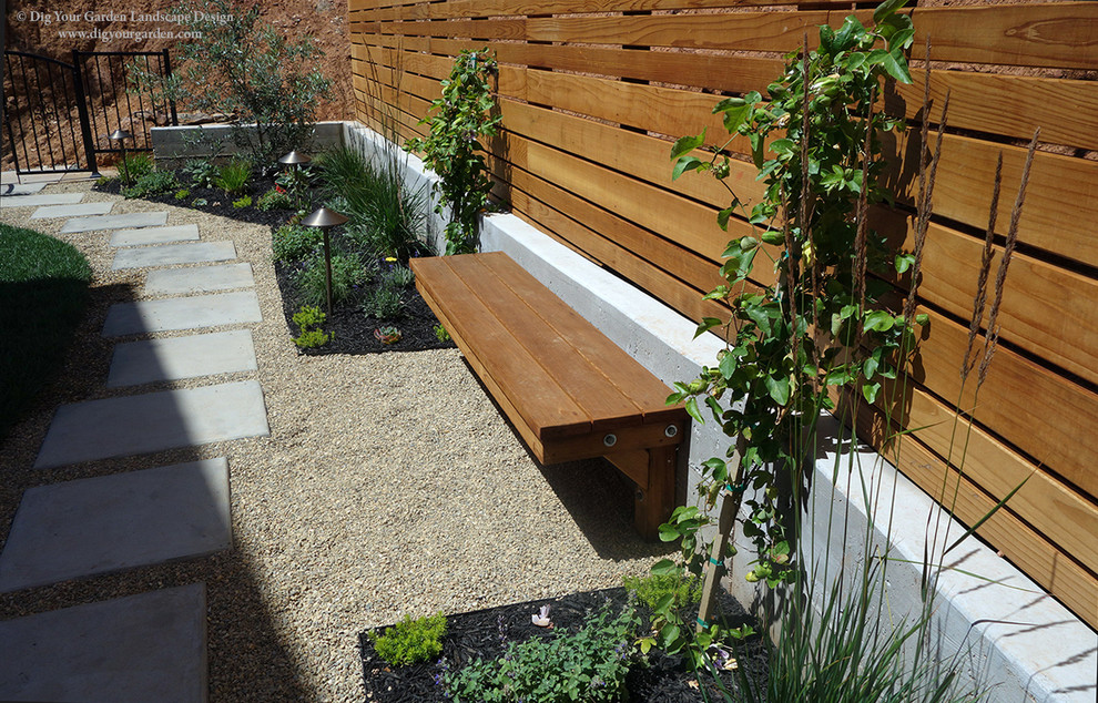 This is an example of a medium sized contemporary back xeriscape full sun garden for summer in San Francisco with a garden path and concrete paving.