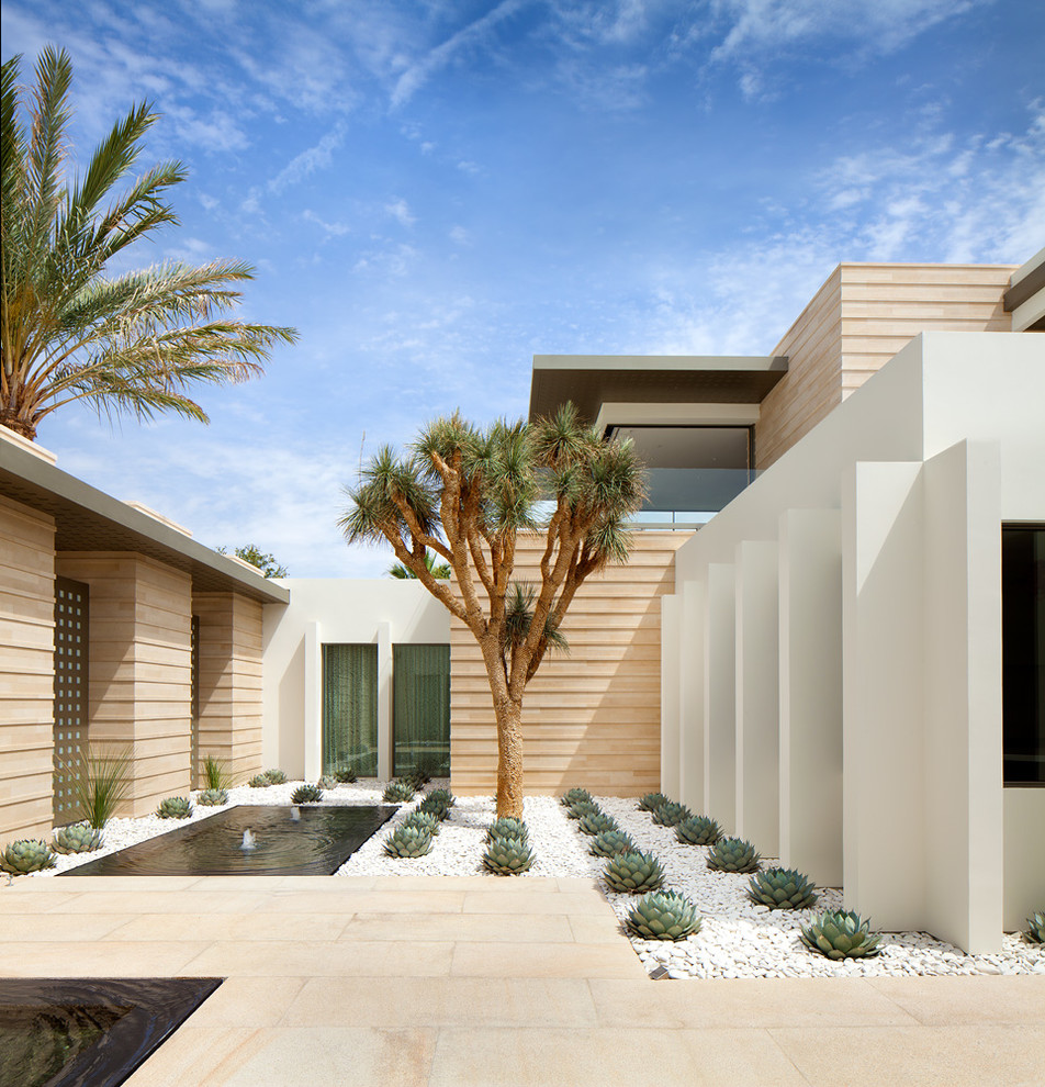 Photo of a small contemporary full sun and desert courtyard stone landscaping in Los Angeles for summer.