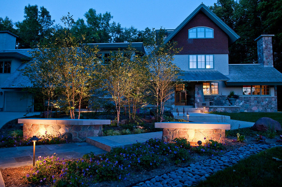 Photo of a large contemporary front garden in Milwaukee with a retaining wall and natural stone paving.