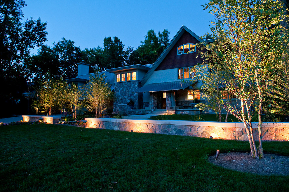 Foto di un grande giardino design davanti casa con un muro di contenimento e pavimentazioni in pietra naturale