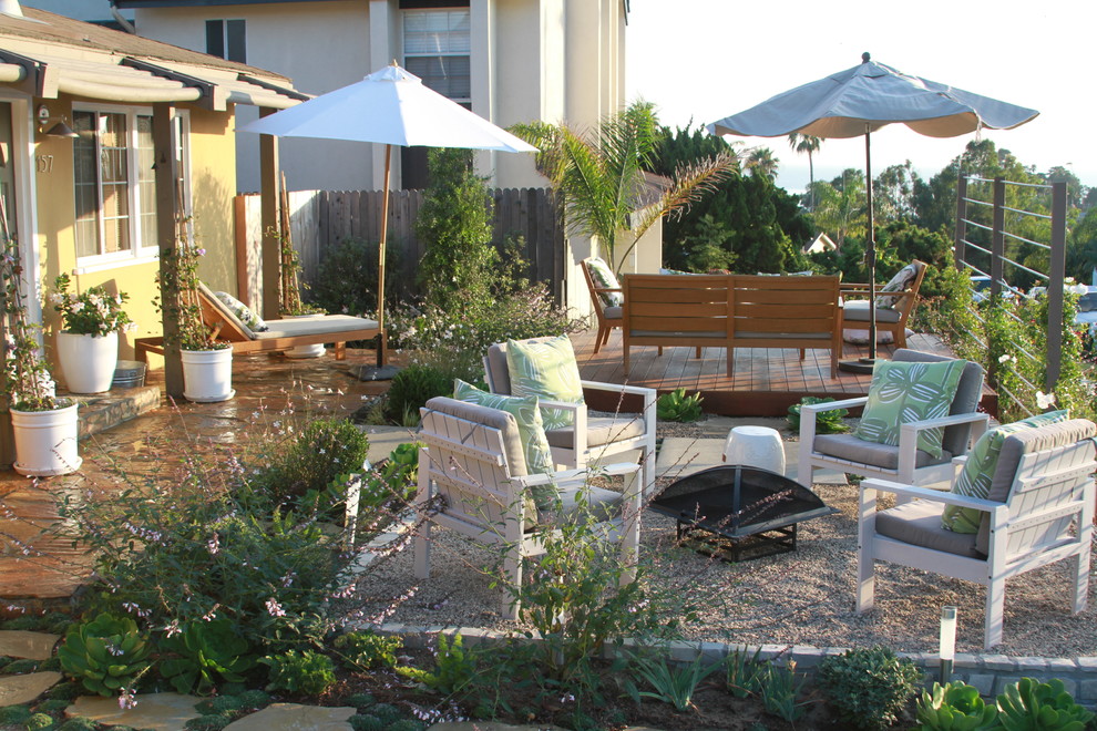 Design ideas for a contemporary back garden in Orange County with a fire feature and gravel.