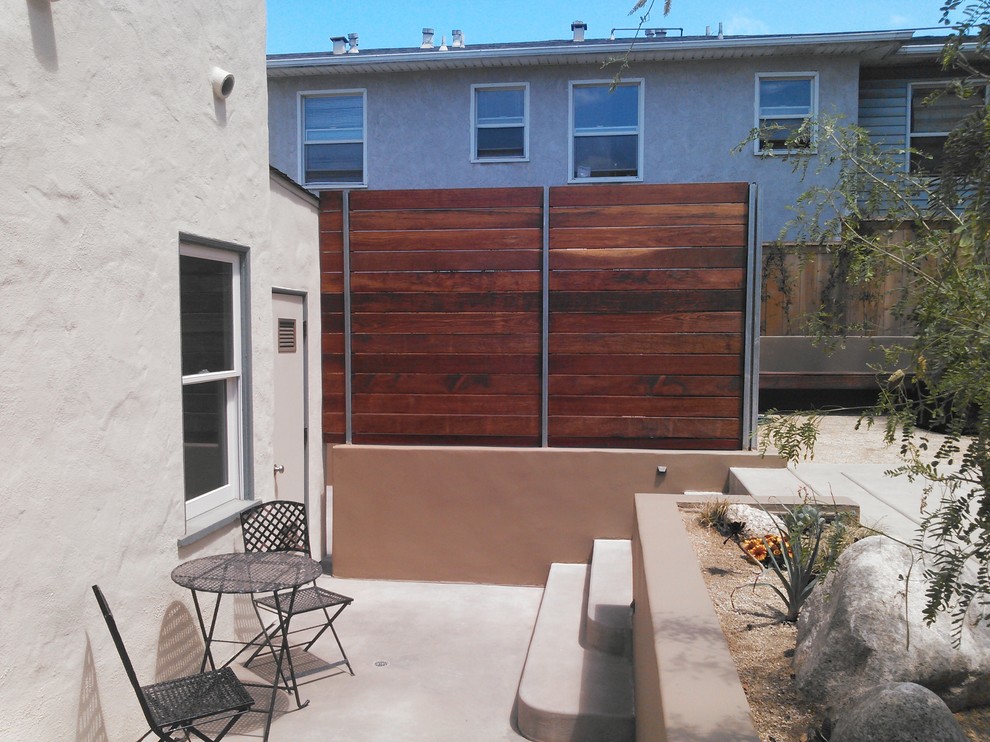 Photo of a large contemporary back xeriscape full sun garden in San Diego with a retaining wall.