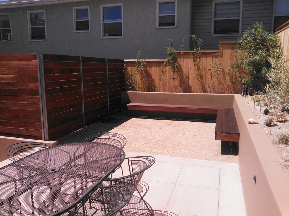 Inspiration for a large contemporary back xeriscape full sun garden in San Diego with a retaining wall.