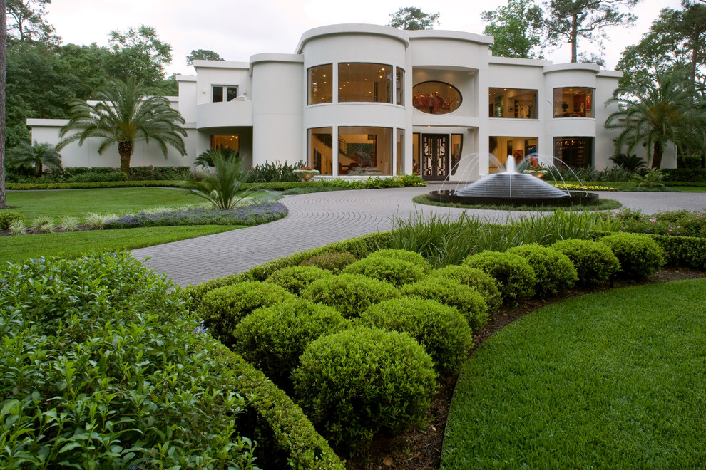 This is an example of a contemporary partial sun front yard concrete paver water fountain landscape in Houston for summer.