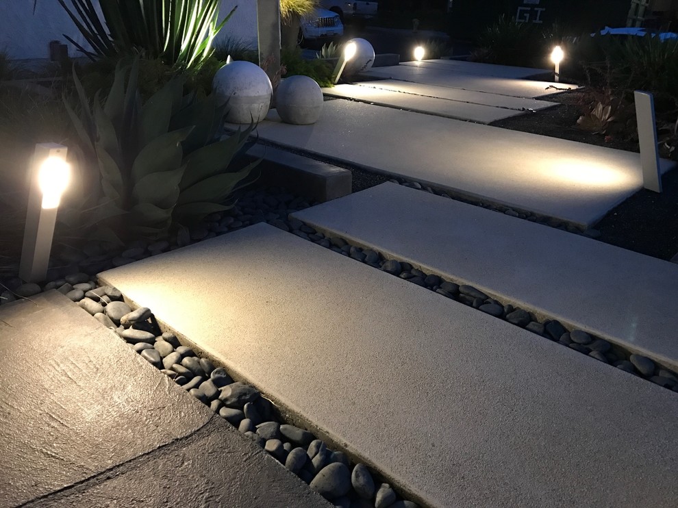 Photo of a large contemporary front formal fully shaded garden in Los Angeles with a garden path and concrete paving.