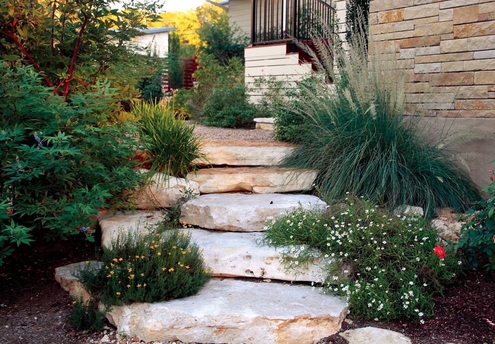 Small classic back partial sun garden for summer in Austin with a garden path and natural stone paving.