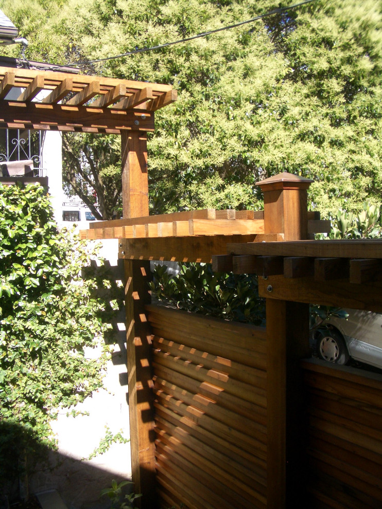 This is an example of a small transitional privacy and shade courtyard stone landscaping in San Francisco.