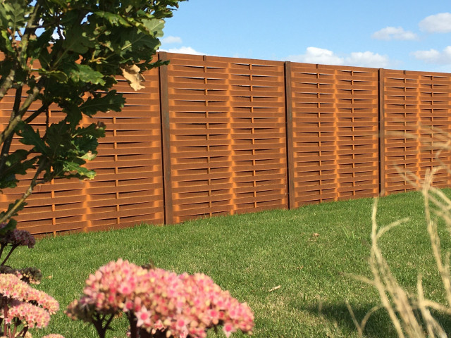 Corten metal fencing panels. A familiar post and panel fencing system