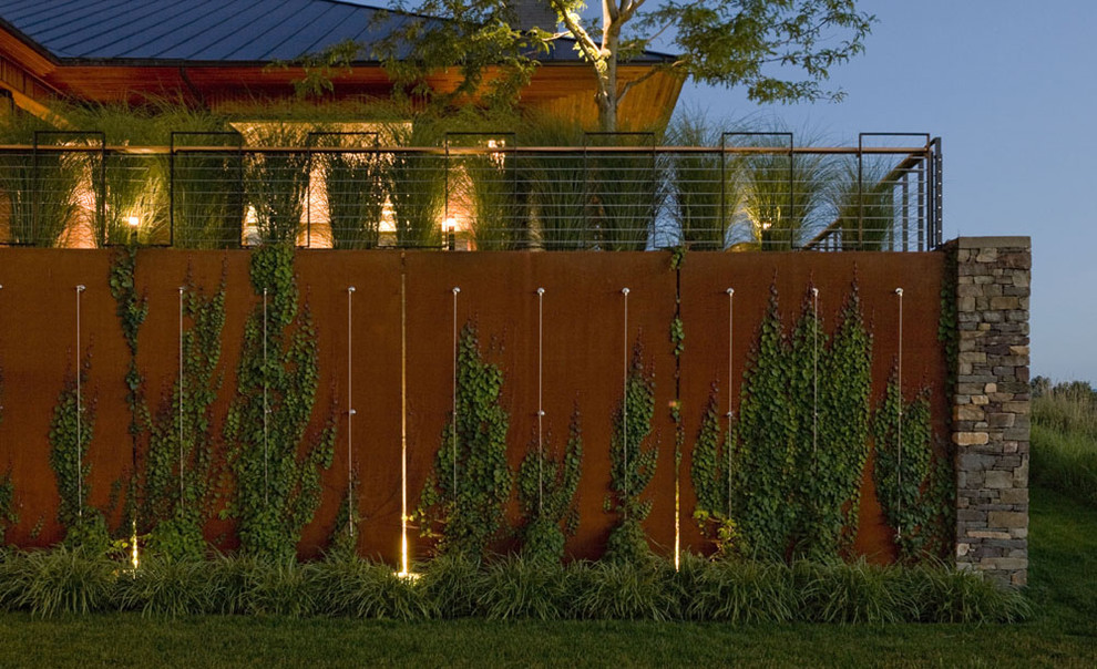 Design ideas for an expansive modern sloped partial sun garden in Burlington with a living wall.