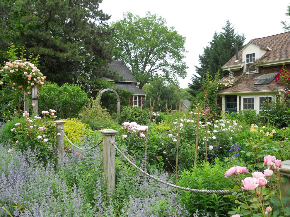 Medium sized rustic front formal full sun garden in Providence with a garden path.