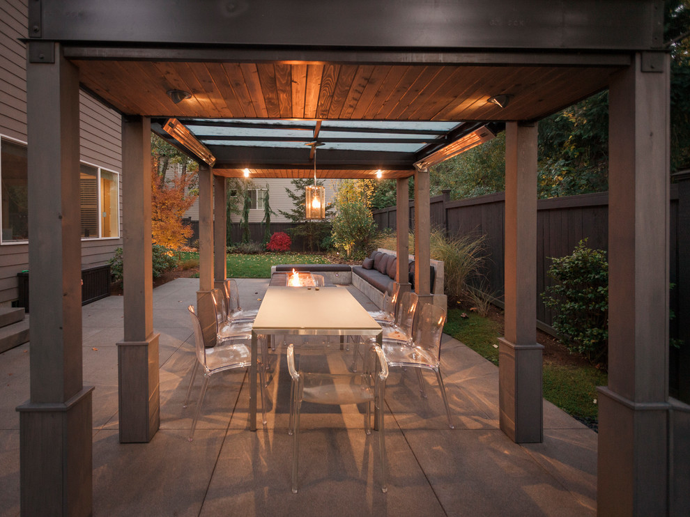 Inspiration for a mid-sized modern full sun backyard concrete paver formal garden in Seattle with a fireplace.