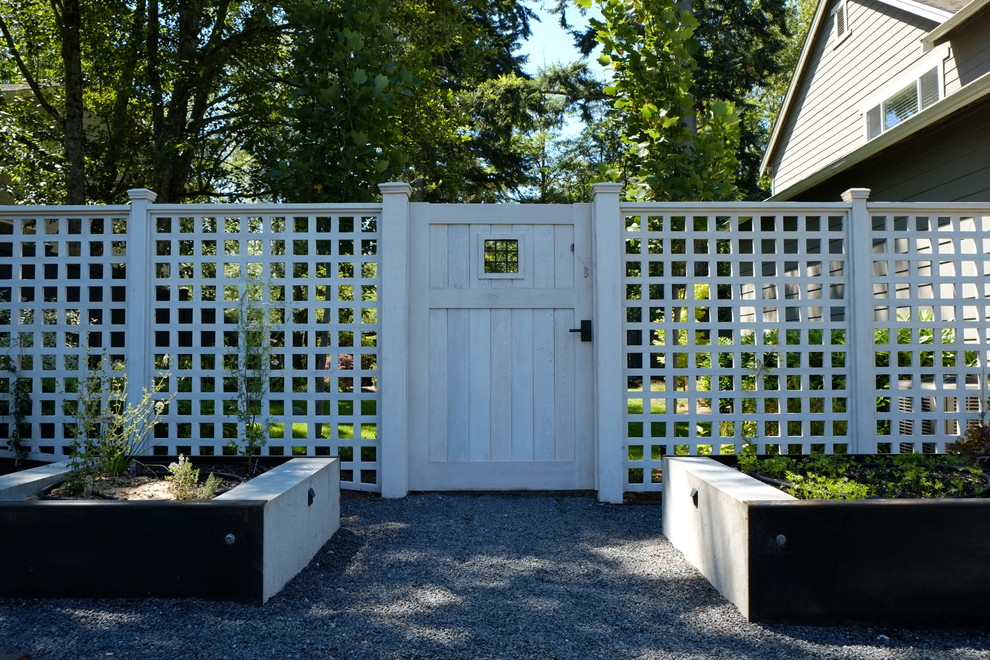 Design ideas for a mid-sized modern partial sun backyard mulch formal garden in Seattle.