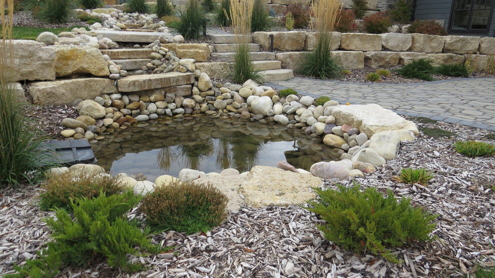 This is an example of a large traditional backyard concrete paver pond in Calgary for fall.