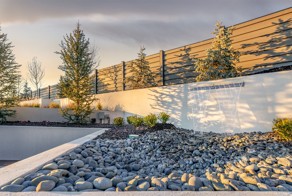 Inspiration for an expansive contemporary back garden in Salt Lake City with a water feature and concrete paving.
