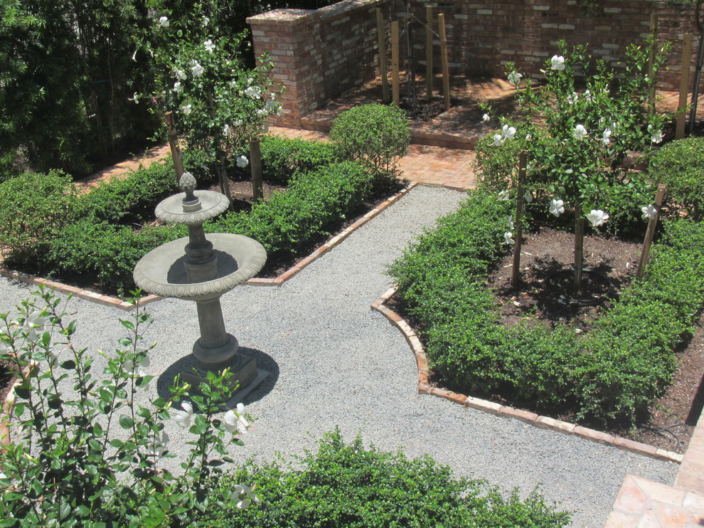 Modelo de jardín clásico pequeño en patio con jardín francés, fuente, exposición total al sol y adoquines de ladrillo