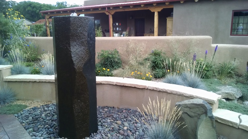 Full sun garden for summer in Albuquerque with natural stone paving.