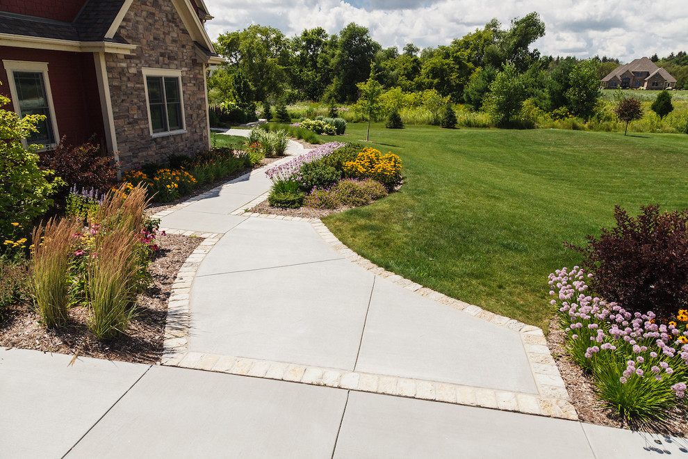 Idee per un grande giardino xeriscape american style esposto in pieno sole davanti casa in estate con pavimentazioni in pietra naturale