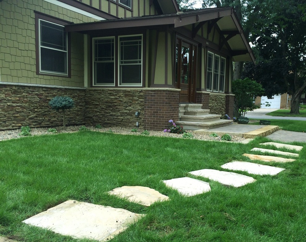 Inspiration for a large craftsman full sun front yard stone landscaping in Other.