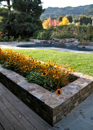 Medium sized classic back formal full sun garden for summer in San Francisco with a water feature and decking.