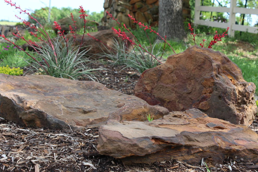 Inspiration for a large traditional partial sun front yard stone landscaping in Dallas for spring.