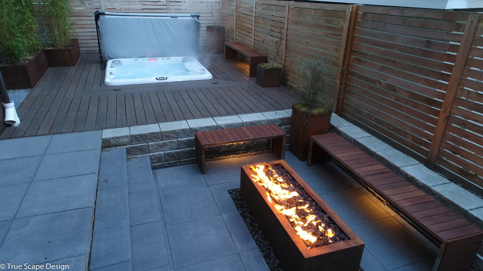 Design ideas for a small modern drought-tolerant and shade backyard concrete paver landscaping in Seattle with a fire pit.