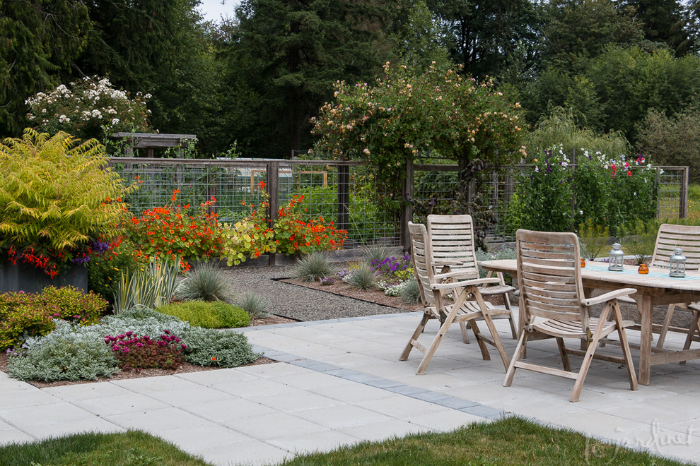 This is an example of a rustic concrete paver vegetable garden landscape in Seattle.
