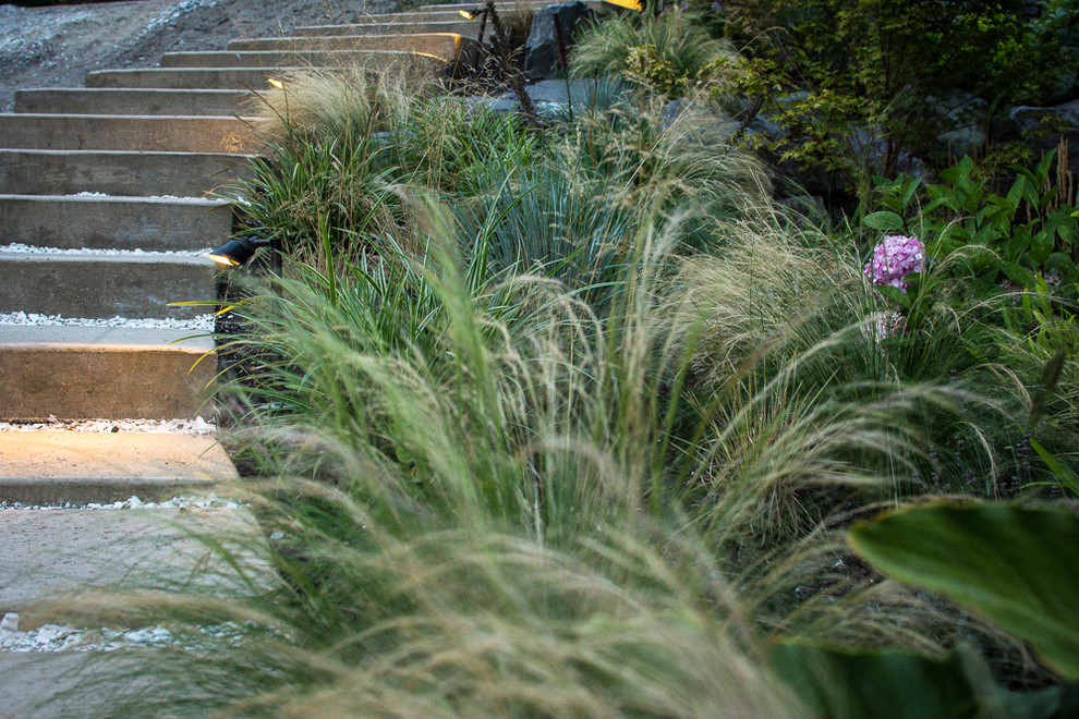 Inspiration for a coastal full sun hillside concrete paver landscaping in Seattle.