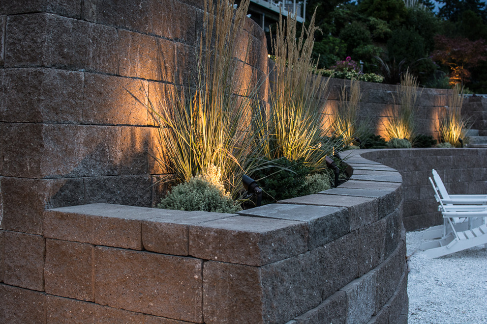 Design ideas for a coastal full sun hillside concrete paver retaining wall landscape in Seattle.
