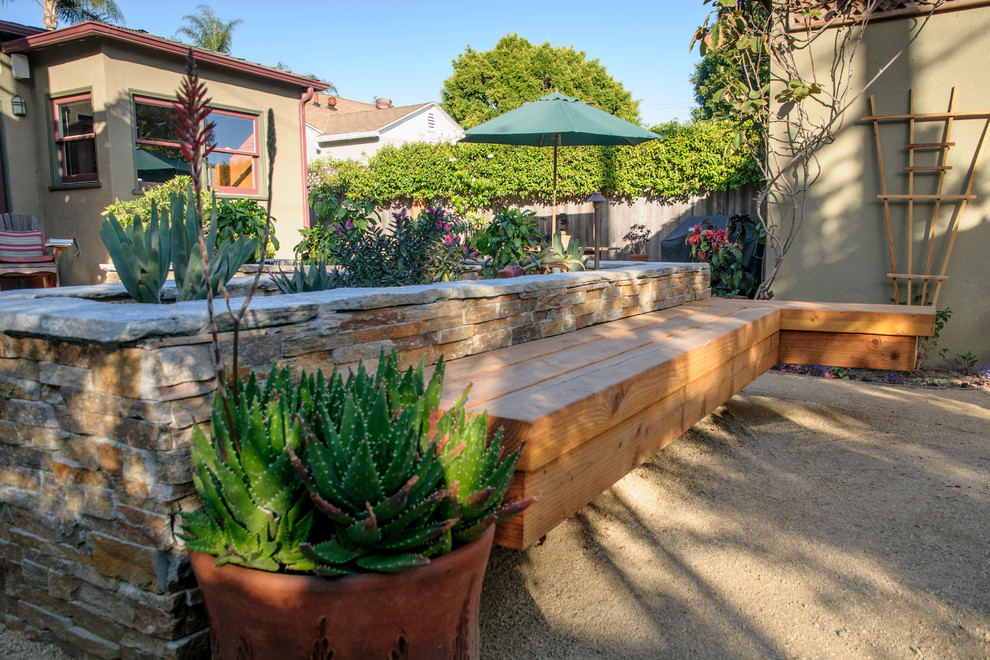 Photo of a mid-sized traditional partial sun backyard gravel landscaping in Los Angeles.