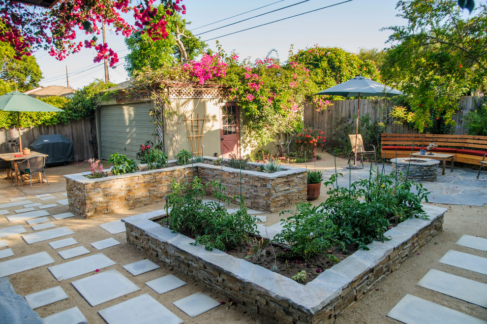 This is an example of a medium sized classic back formal partial sun garden seating in Los Angeles with a vegetable patch and gravel.