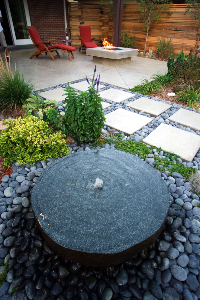 Inspiration for a contemporary water fountain landscape in Denver.