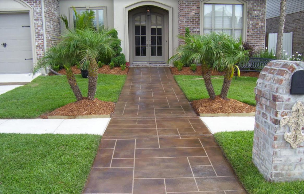 Design ideas for a mid-sized traditional full sun front yard concrete paver landscaping in Other for spring.