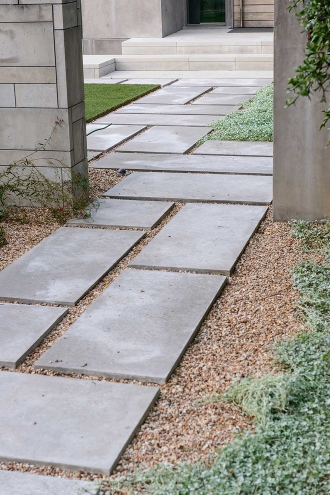 Ispirazione per un giardino formale minimalista esposto in pieno sole di medie dimensioni e davanti casa in primavera con un ingresso o sentiero e pavimentazioni in pietra naturale
