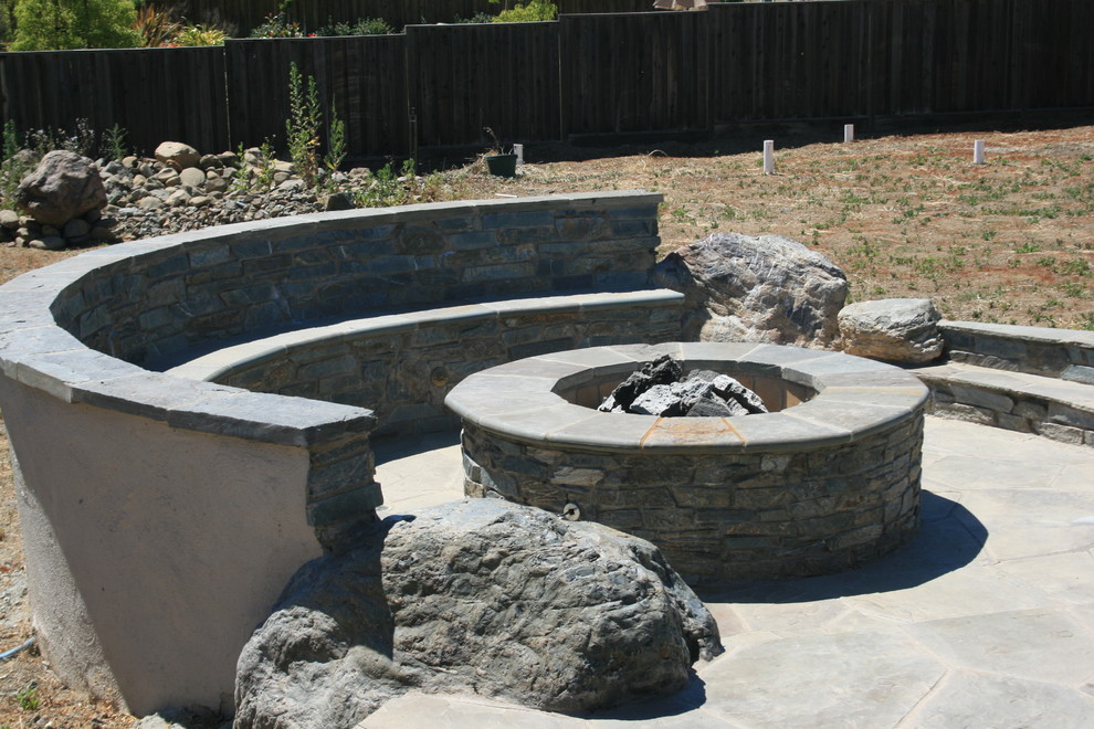 Design ideas for a mid-sized traditional full sun backyard stone landscaping in San Francisco with a fire pit for summer.