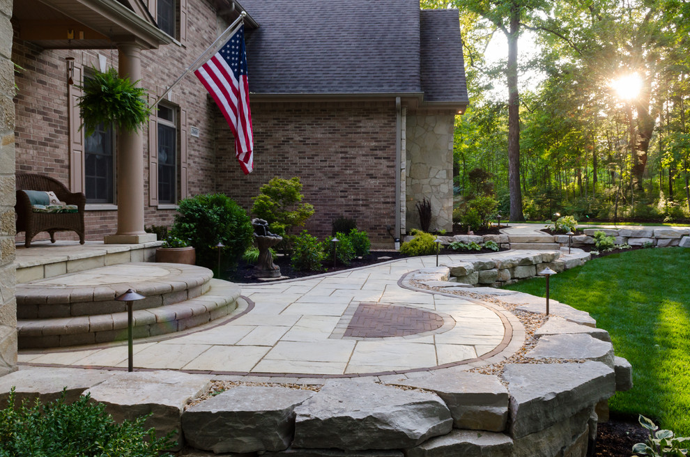 Photo of a large traditional full sun front yard stone landscaping in Chicago for spring.