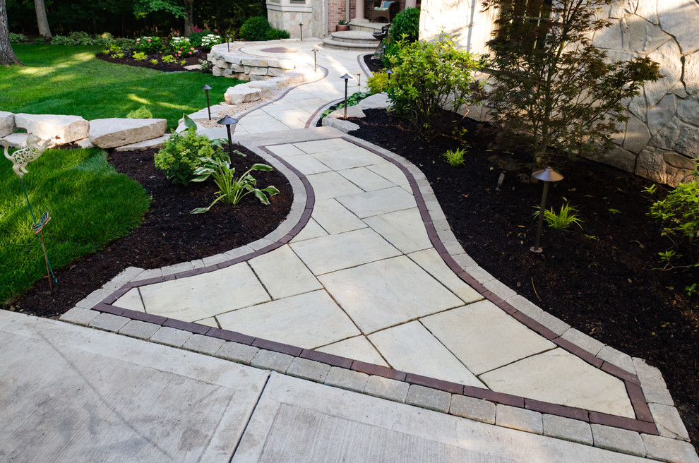 Inspiration for a large classic front formal full sun garden for summer in Chicago with a garden path and natural stone paving.