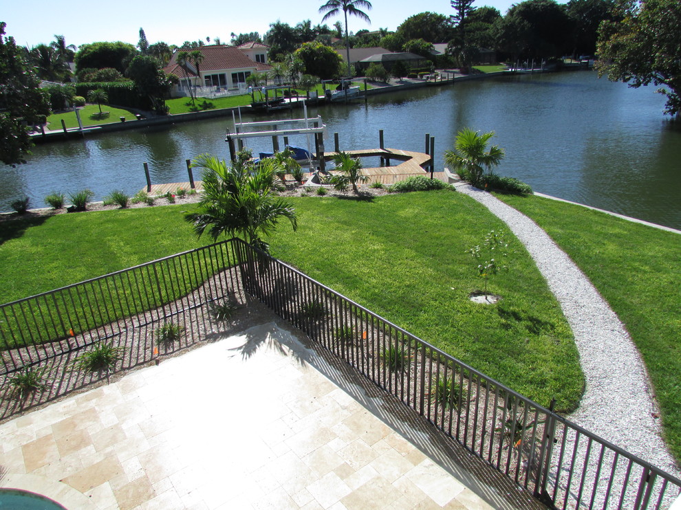 Inspiration for a medium sized coastal side full sun garden in Miami with natural stone paving.