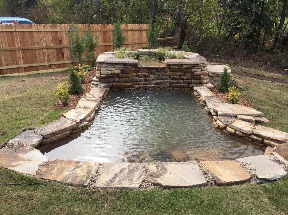 This is an example of a large asian full sun backyard stone landscaping in Other.