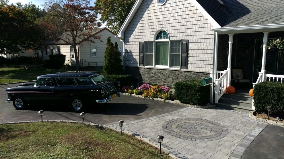 Medium sized traditional front driveway garden in New York with concrete paving.
